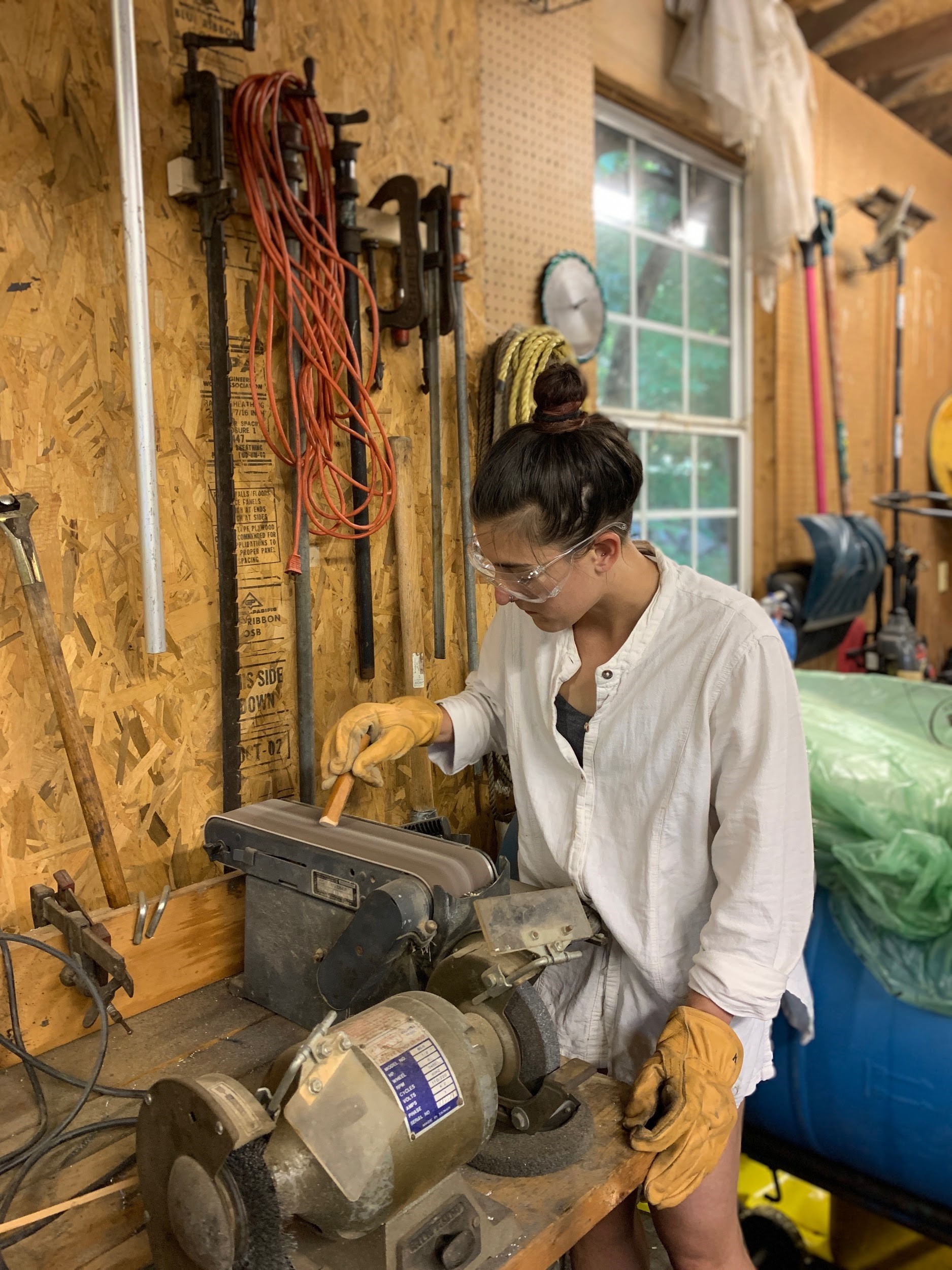 Olivia sanding down our device’s wooden handle.