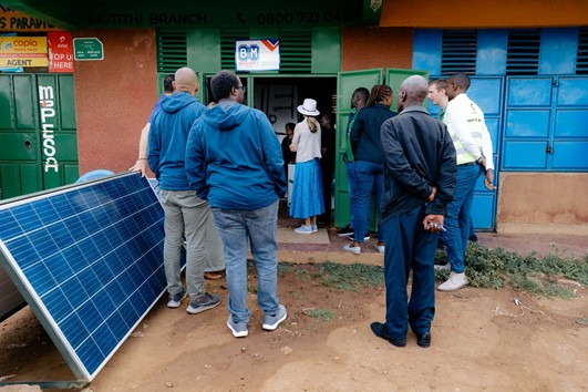 Group standing in an entryway for SunCulture