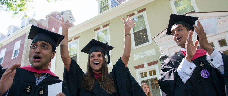 three students celebrating on graduation day