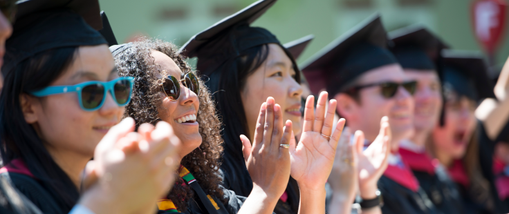 graduate students cheering their mates at commencement ceremony